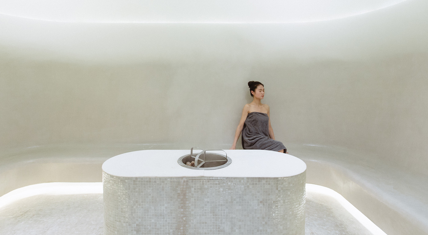 Guest resting in SANGHA thermal therapy space.